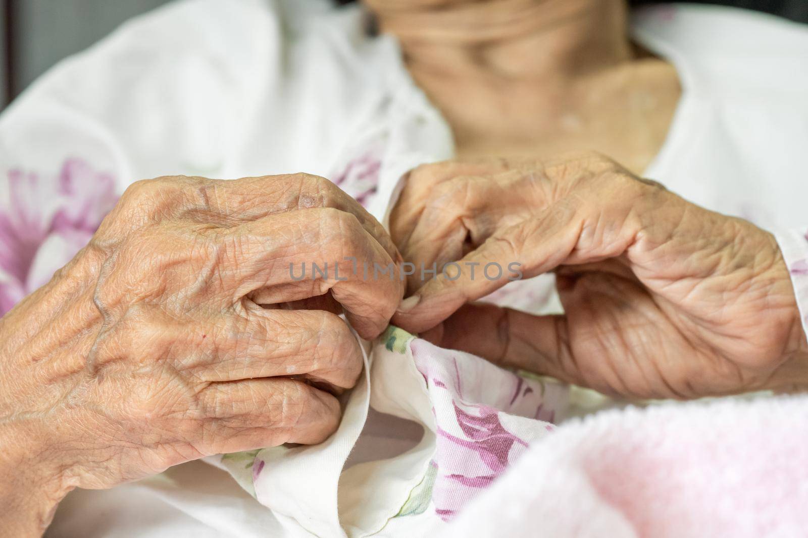 Elderly woman fasten buttons on dress , progressive brain disorder ,Close up hand by toa55