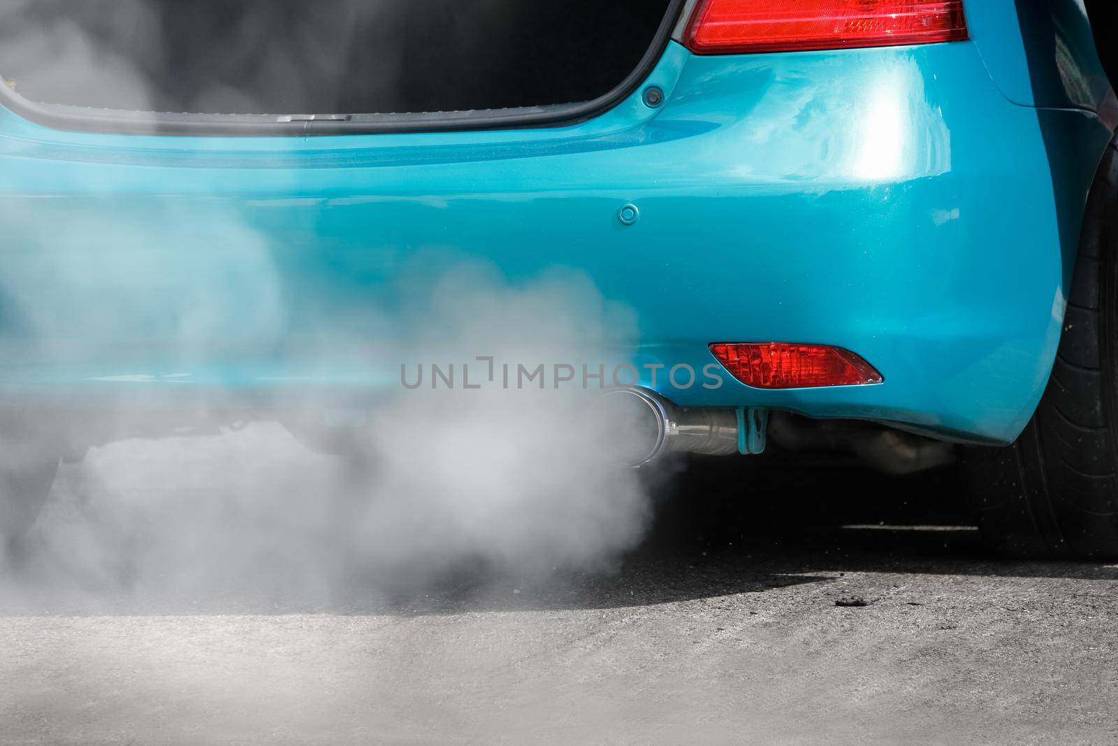 air pollution crisis from car exhaust pipe on road