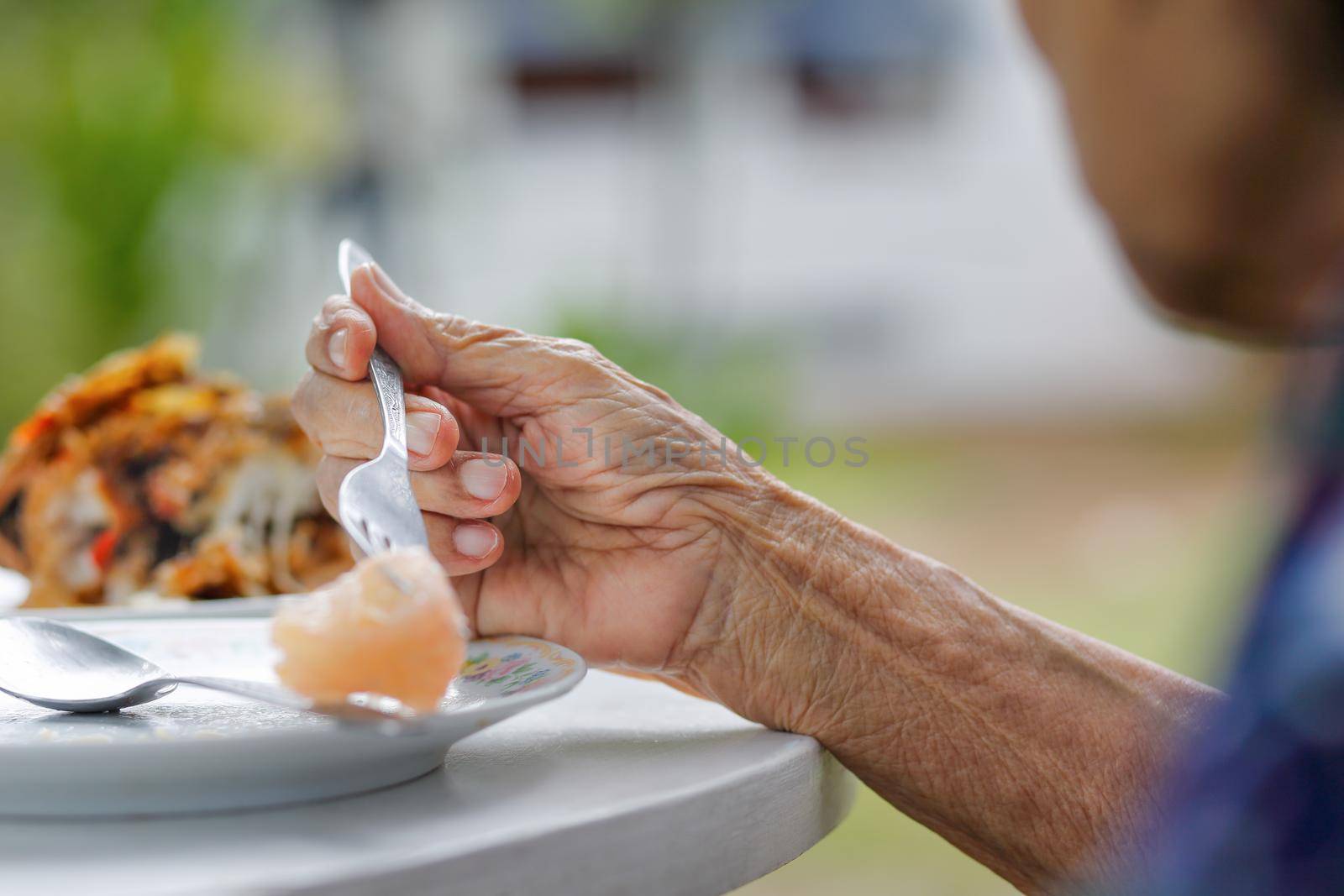 elderly woman have breakfast in backyard