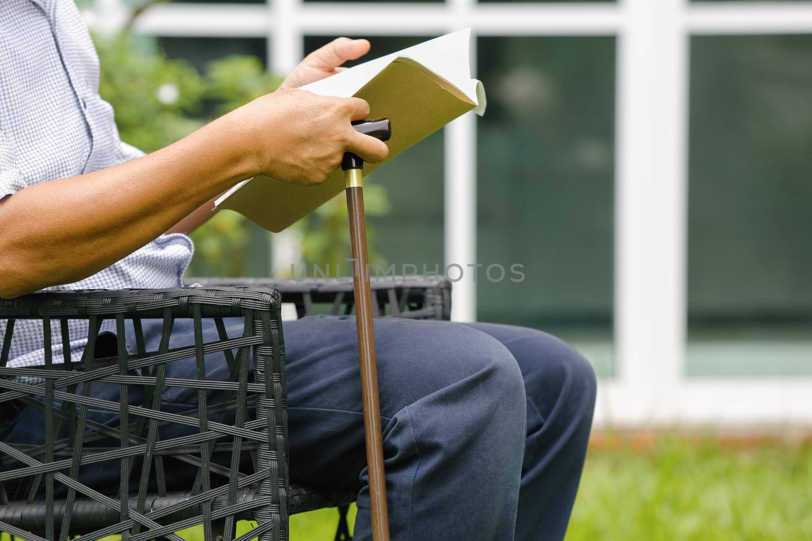 Senior male sitting and relax in backyard