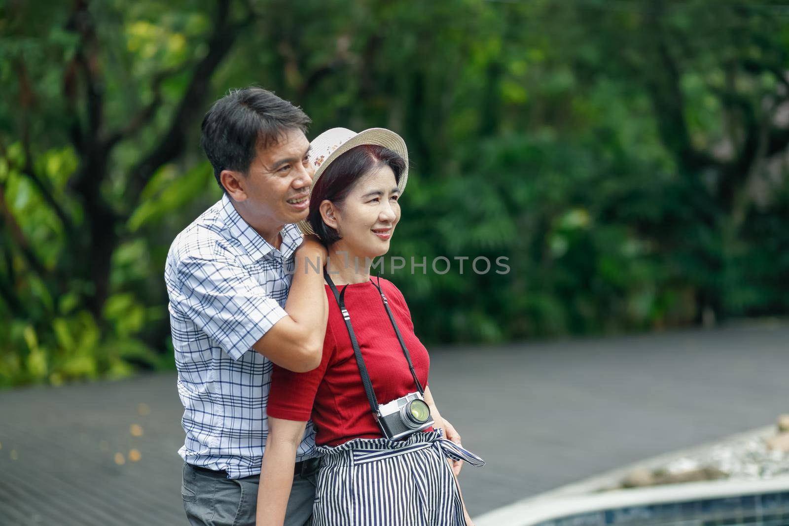 Asian middle aged man relaxing with his wife in anniversary wedding day by toa55