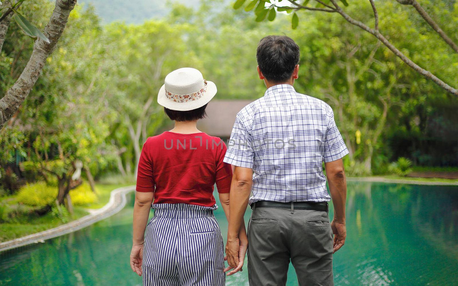 Asian middle aged man relaxing with his wife in anniversary wedding day