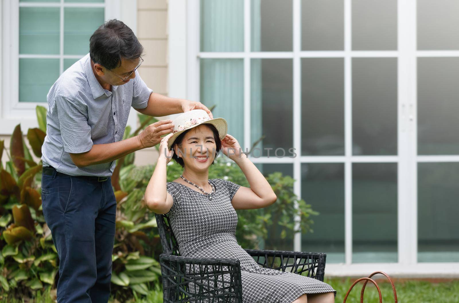 Asian middle aged couple sitting and relax in backyard by toa55