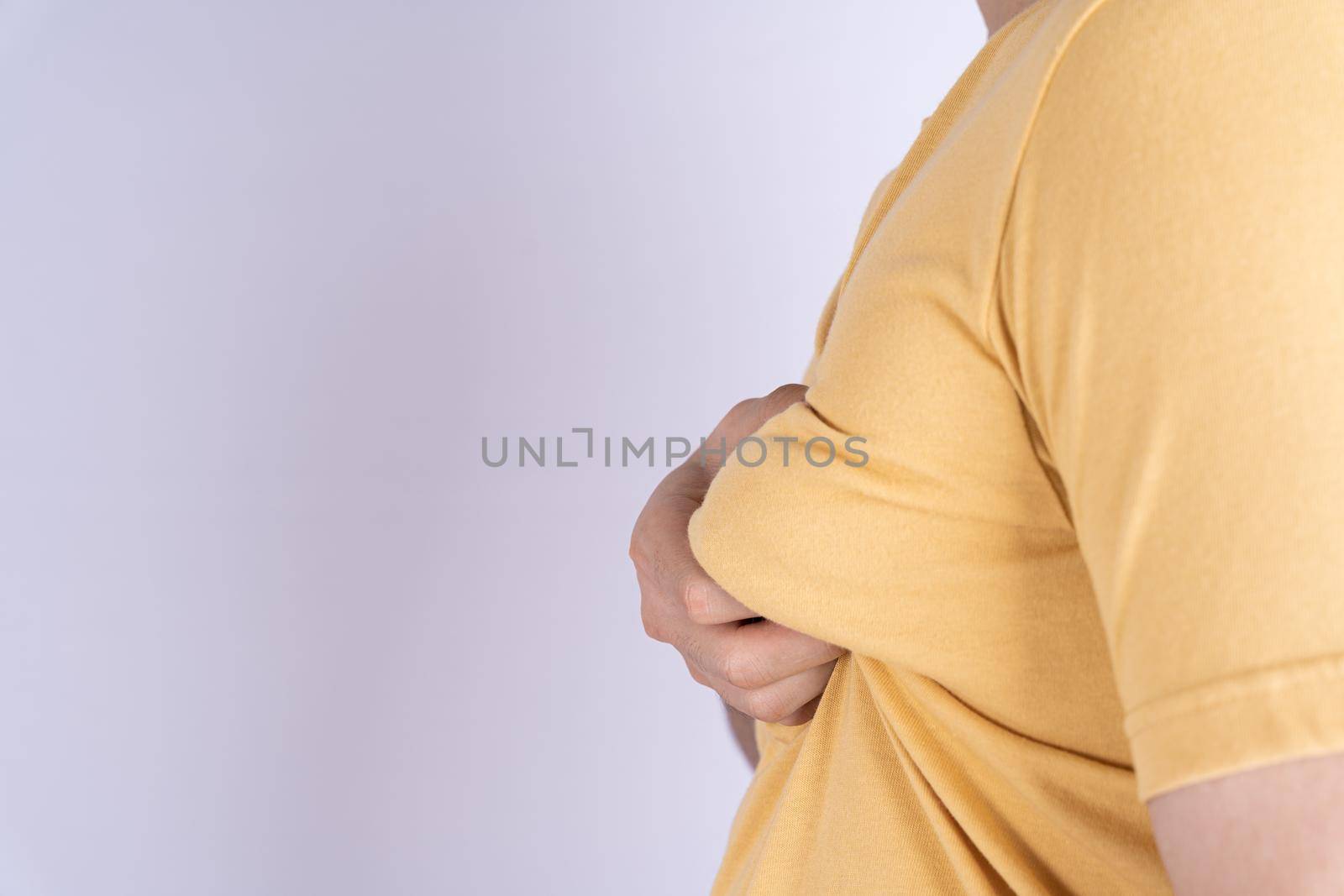 Fat man holding excessive fat boobs isolated grey background. by mikesaran