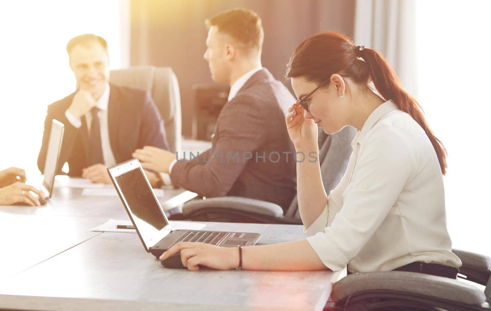 Young attractive business woman working in the office, developing her strategy by selinsmo