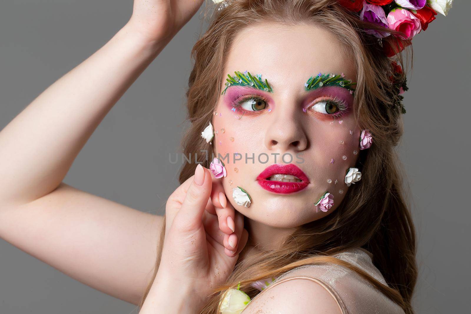 Beautiful spring girl model. Fabulous floral makeup. The face of a girl with extended eyebrows.