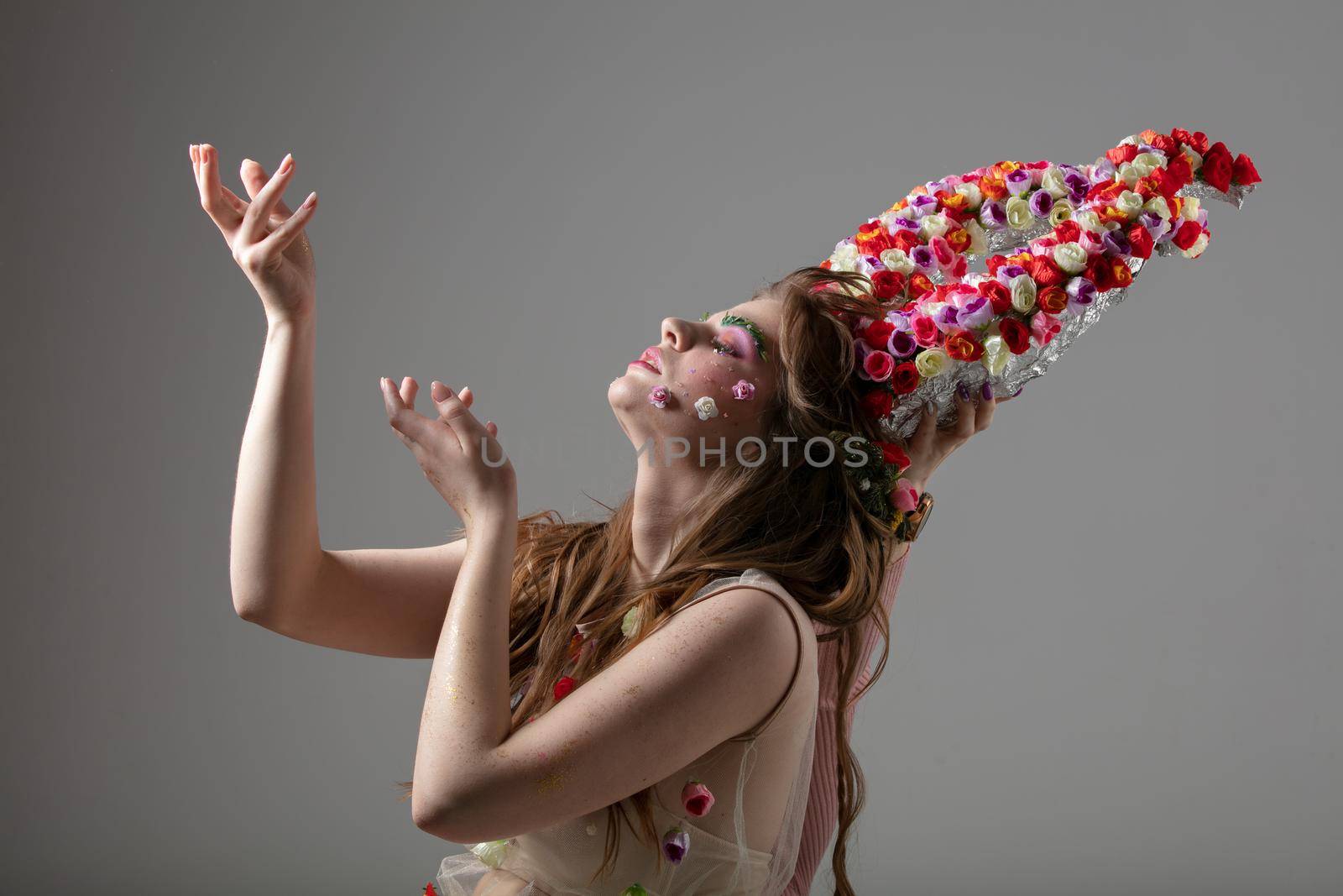 Goddess Lakshmi. Beautiful girl model with flower horns. Malifesenta. Spring girl. Goddess of flowers Flora.