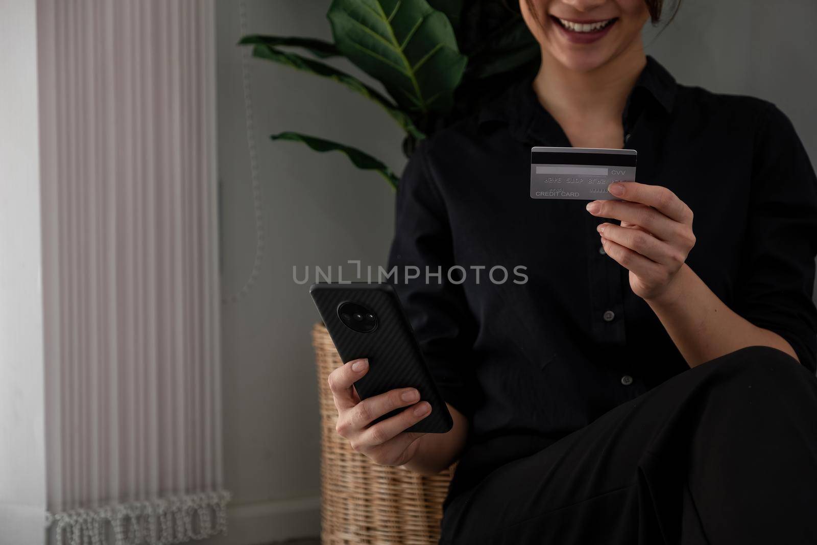 Asian girl making online payment using smartphone for shopping at home