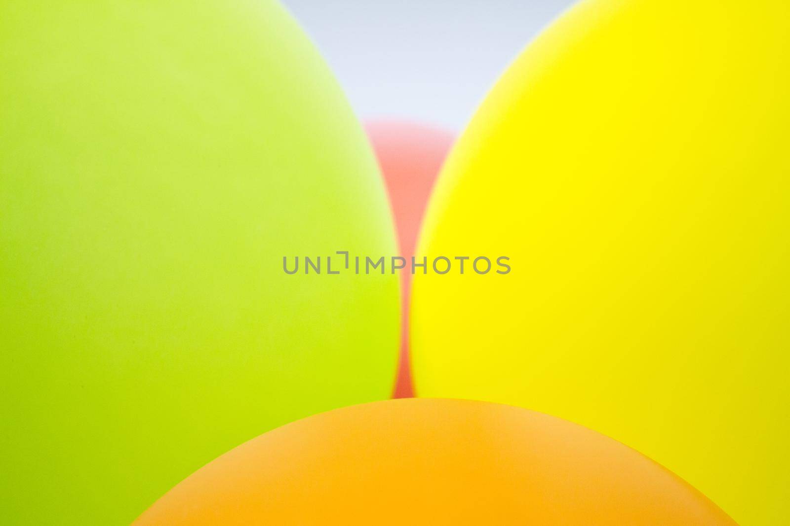Balloons of colors grouped, green, pink, yellow, orange, pink. No people