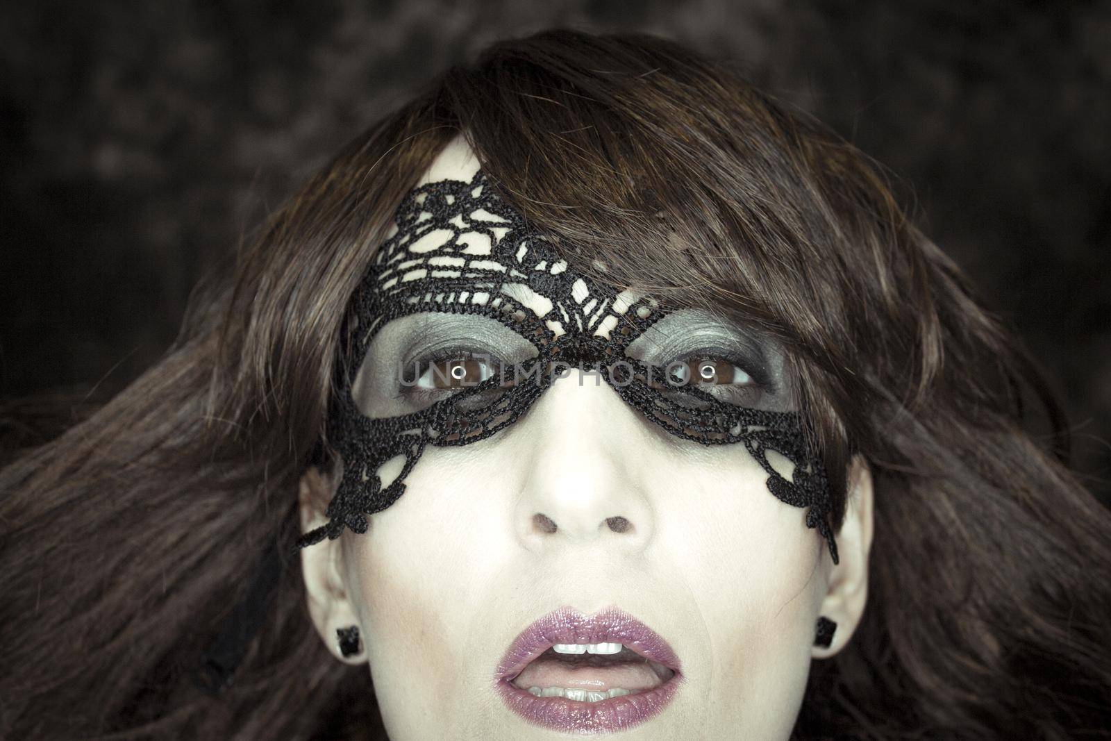 Woman disguised in gothic style for halloween party with mask