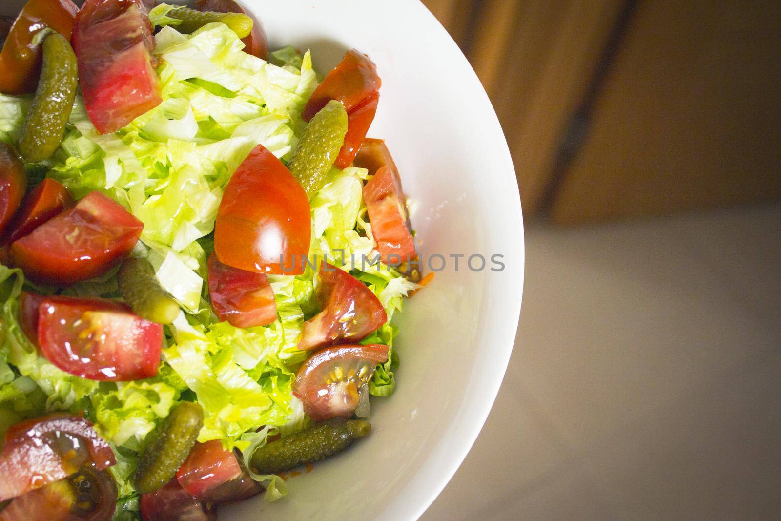 Lettuce salad with tomato and pickles. Raw food