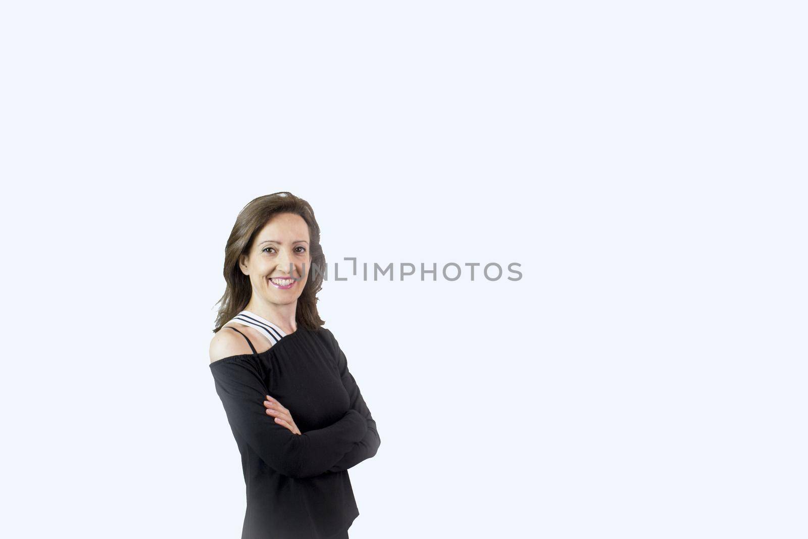 Forty year old woman with happy, joyful and positive expression. Black tshirt and light background