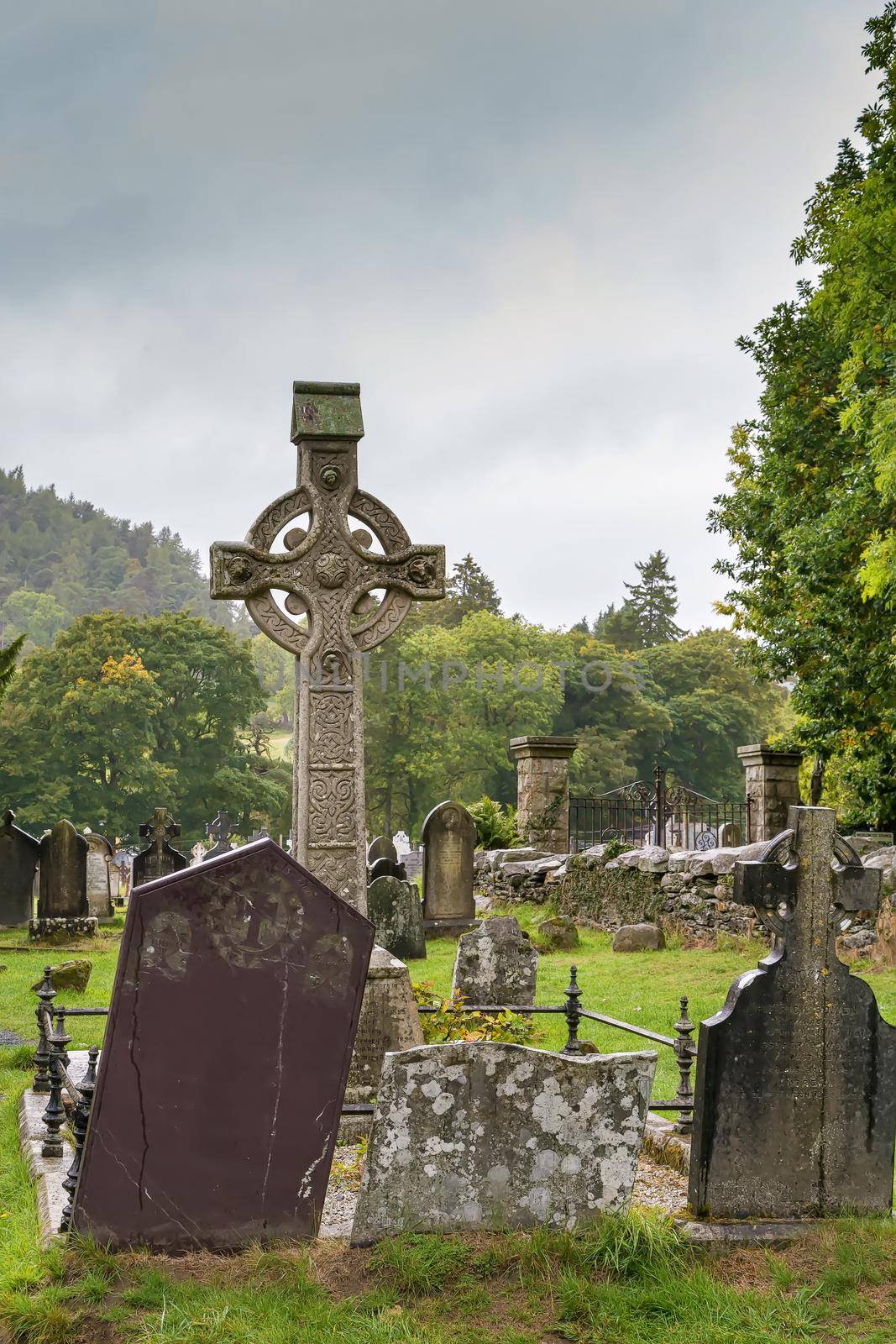 Celtic cross in a graveyard in Glendalough, Ireland