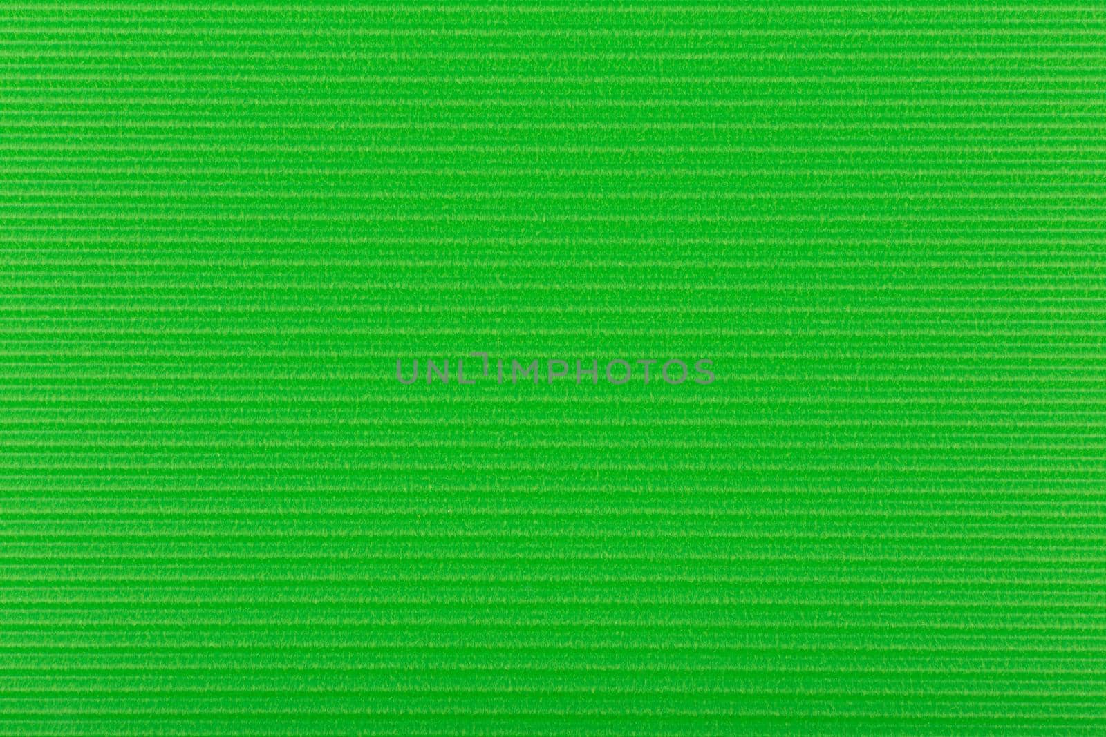 Green wall texture with horizontal stripes. Green paper background. Flay, copy space. 