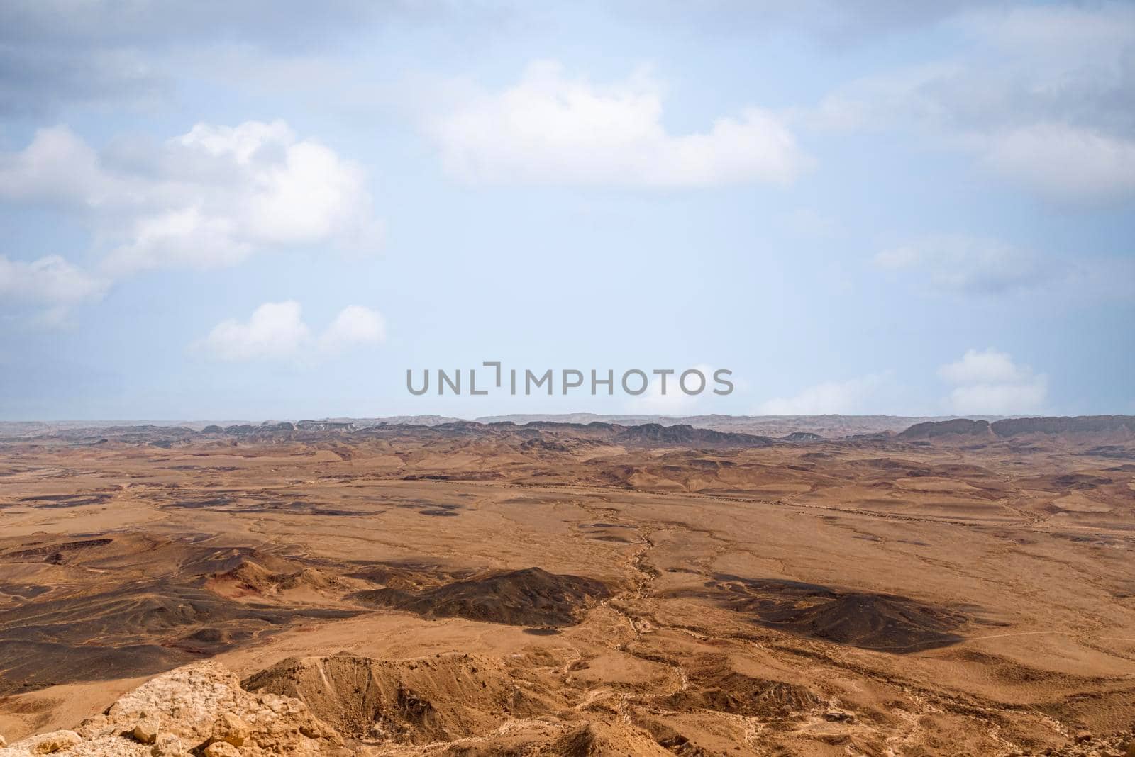 Ramon Crater Makhtesh Ramon, the largest in the world, as seen from the high rocky cliff edge surrounding it from the north, Ramon Nature reserve, Mitzpe Ramon, Negev desert, Israel. High quality photo