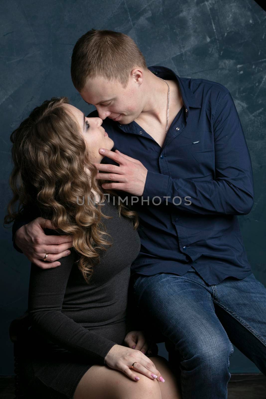 Portrait of a beautiful couple in love on a dark background.