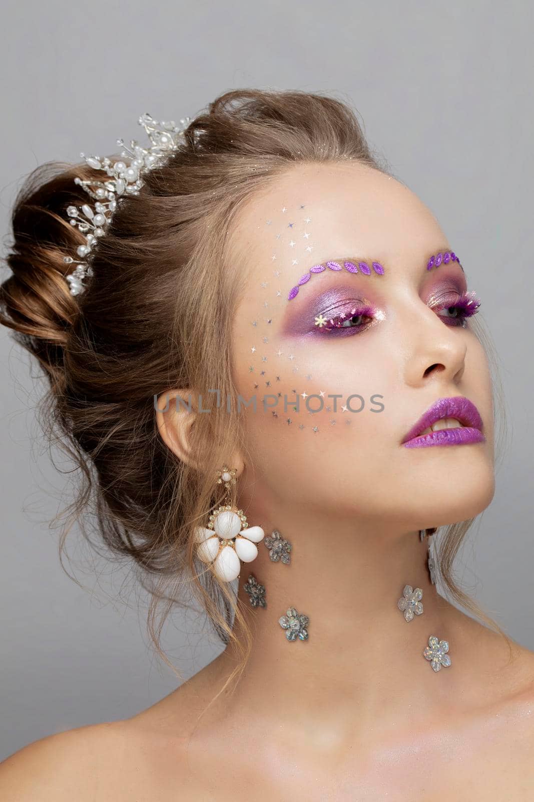 Model face with purple make-up. Beauty with unusual eyebrows. Beautiful girl portrait.