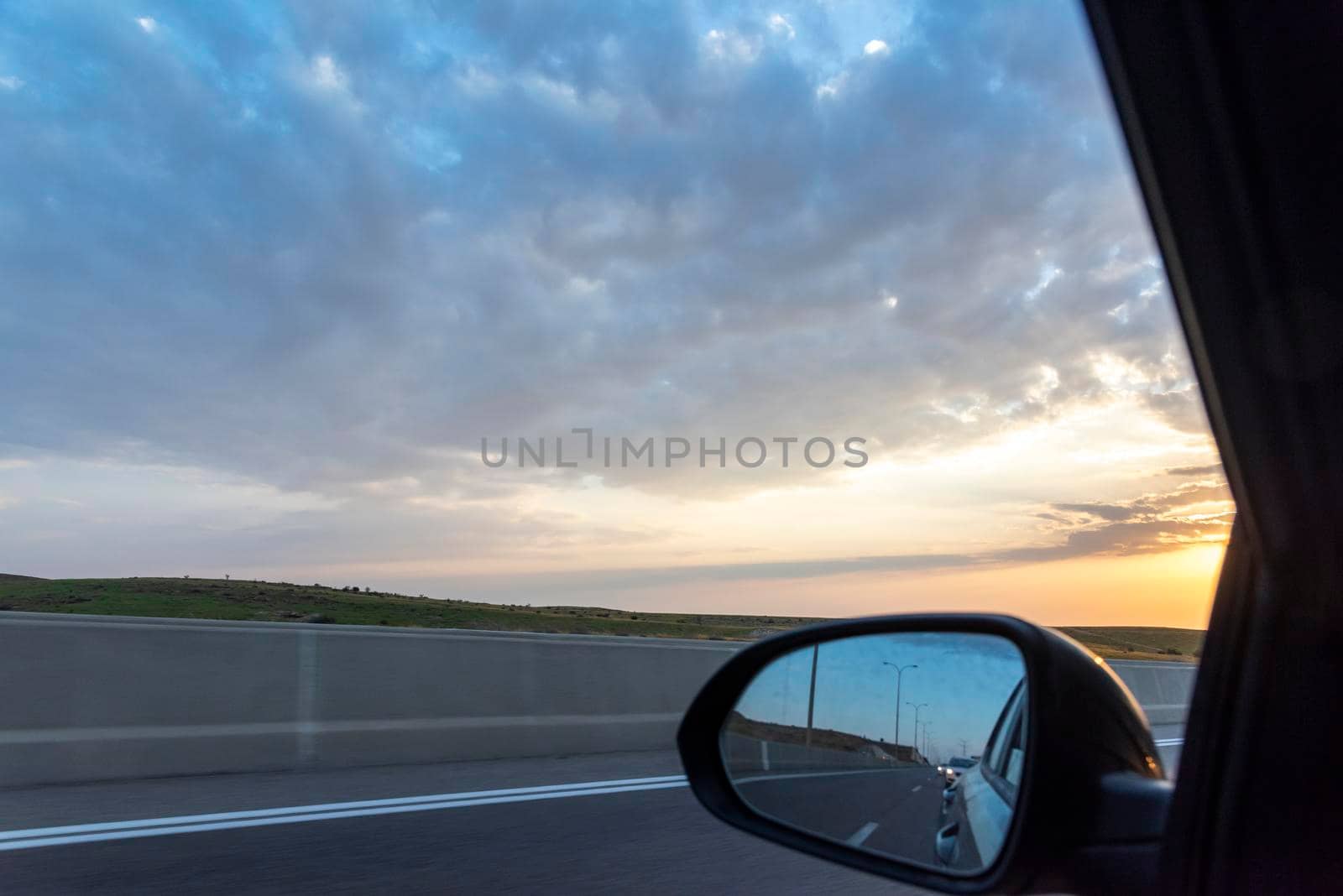 Road and sky seen from the sidecar mirror. High quality photo