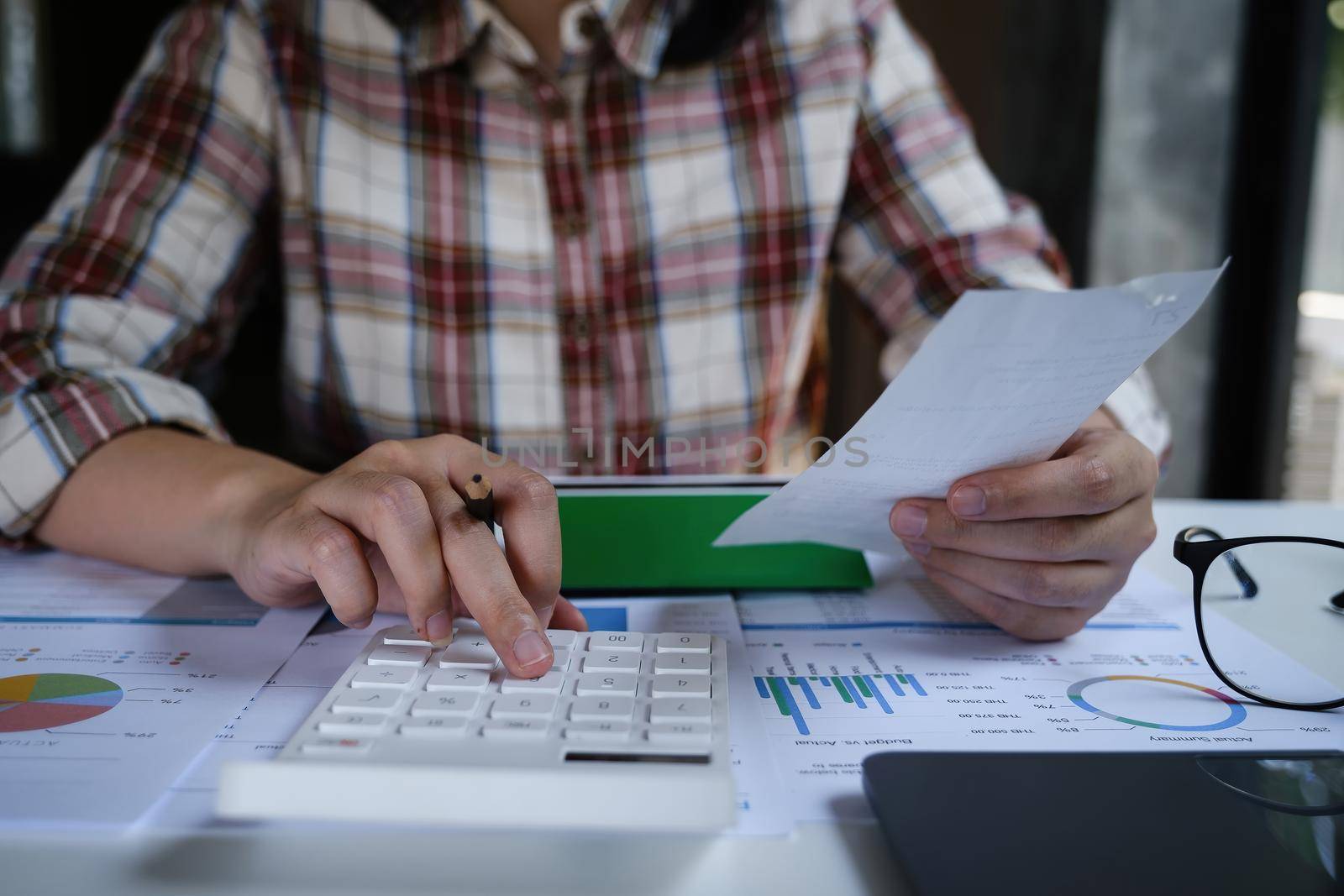 A Men is managing, calculating the debt and holding cost bill. by itchaznong