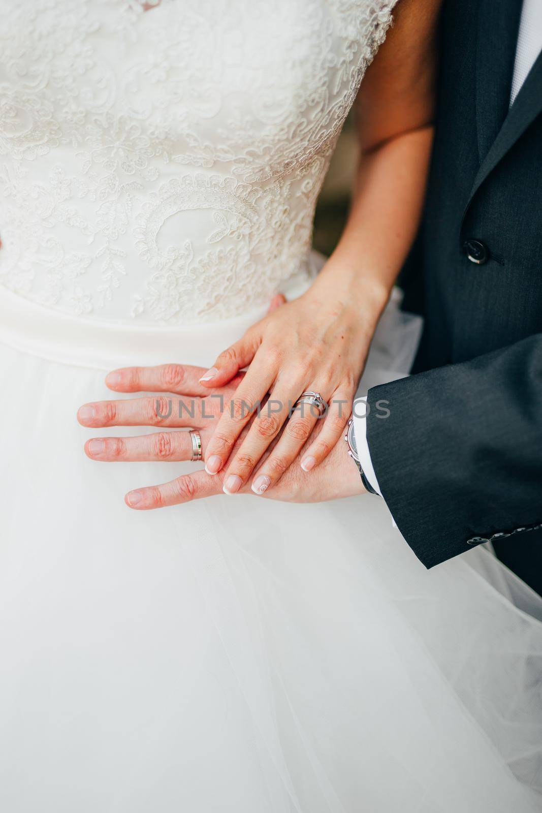 The hands of the newlyweds with rings. Wedding in Montenegro.