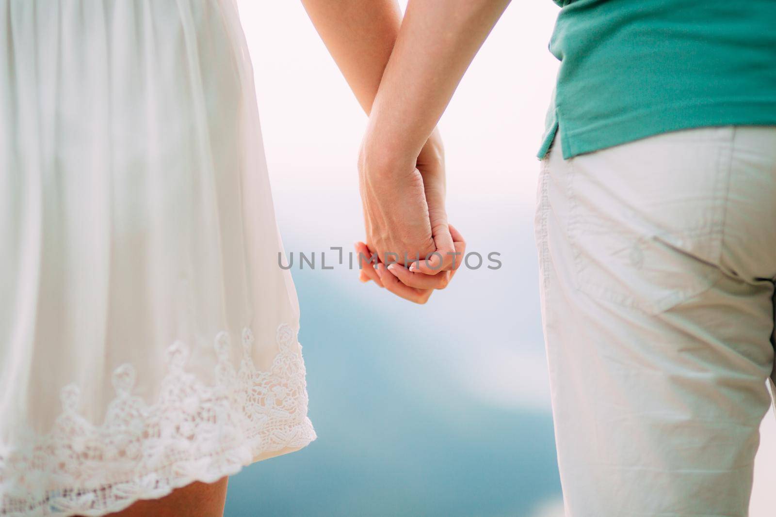The newlyweds hold hands. Couple holding hands. Wedding in Montenegro.