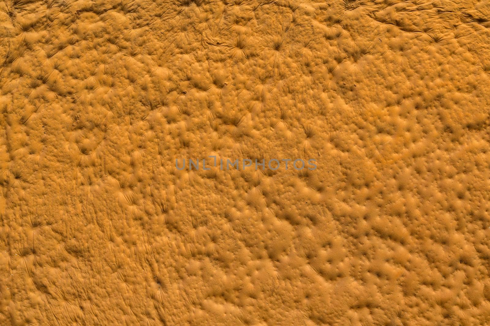 orange sculpturesque plaster with decorative indentation finish wall texture and background