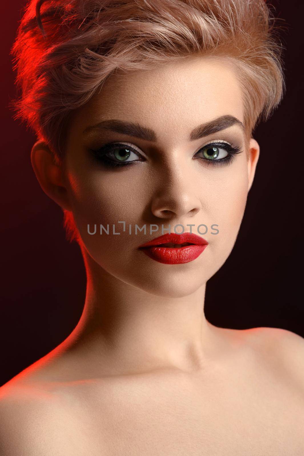 Beautiful young blonde red lipped woman posing in artistic red l by SerhiiBobyk