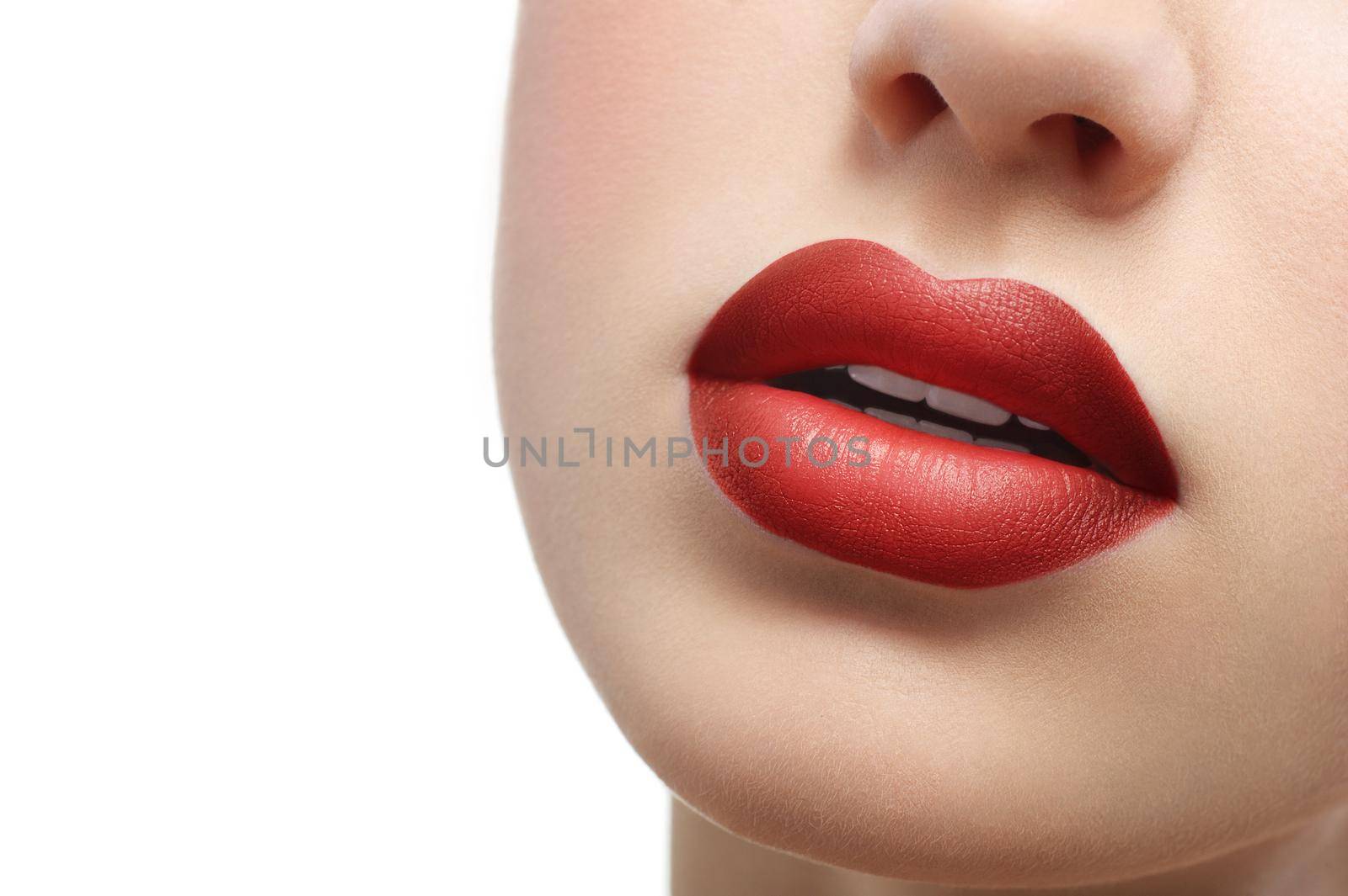 Cropped close up of full sexy sensual lips of a beautiful woman. Red lipstick on sexy plump lips isolated on white copyspace makeup visage sexuality femininity beauty face cosmetics fashion concept