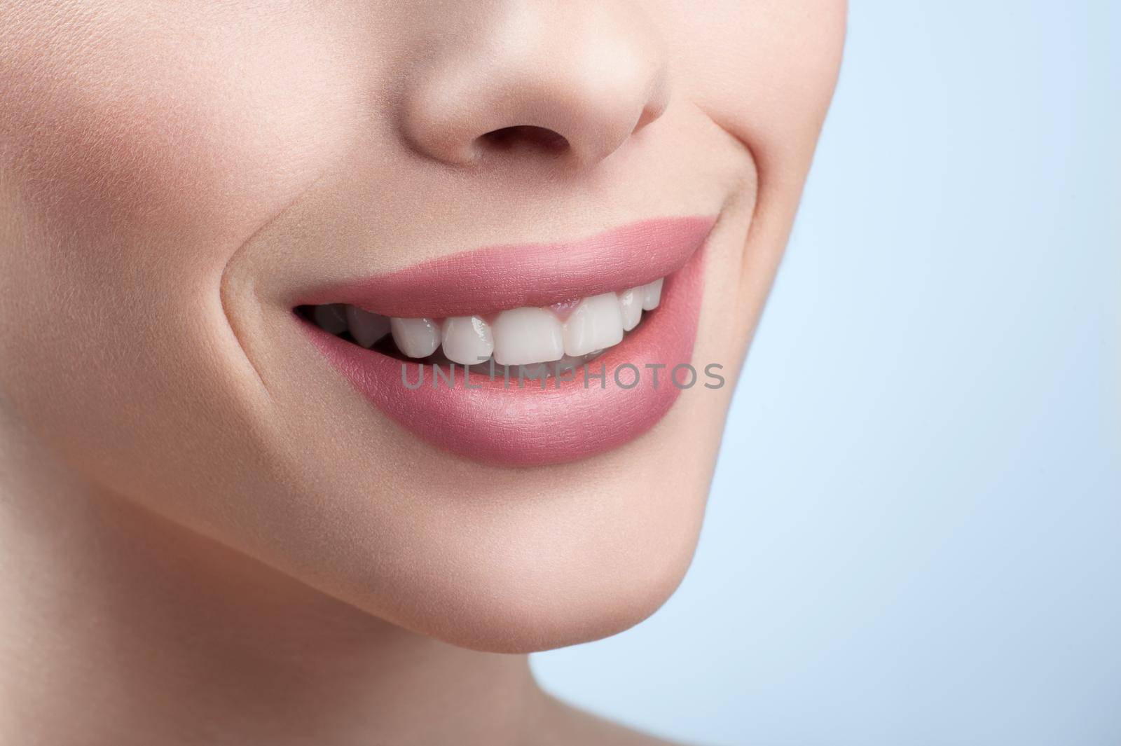 Close up cropped shot of a perfect smile of a woman by SerhiiBobyk