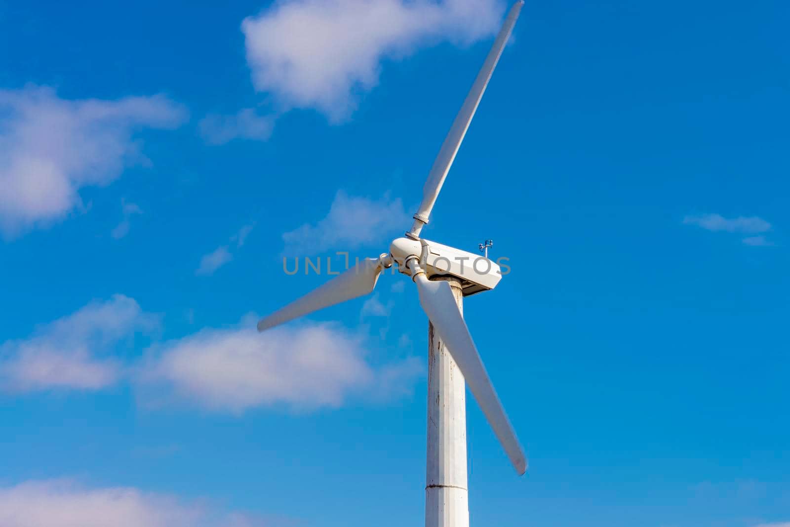 Wind power generator propeller against the blue sky. Industrial landscape. Front and bottom view. by Essffes