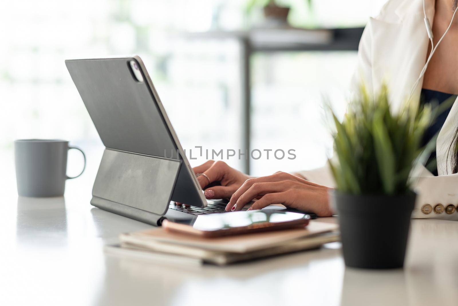 Close up businesswoman using digital tablet with blank white screen at office.