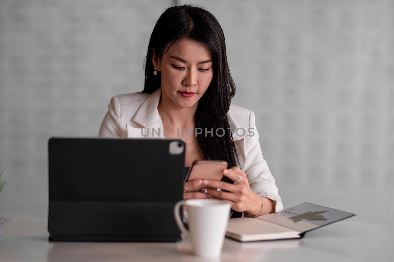 Portrait Of Attractive Asian Businesswoman Working on mobile phone