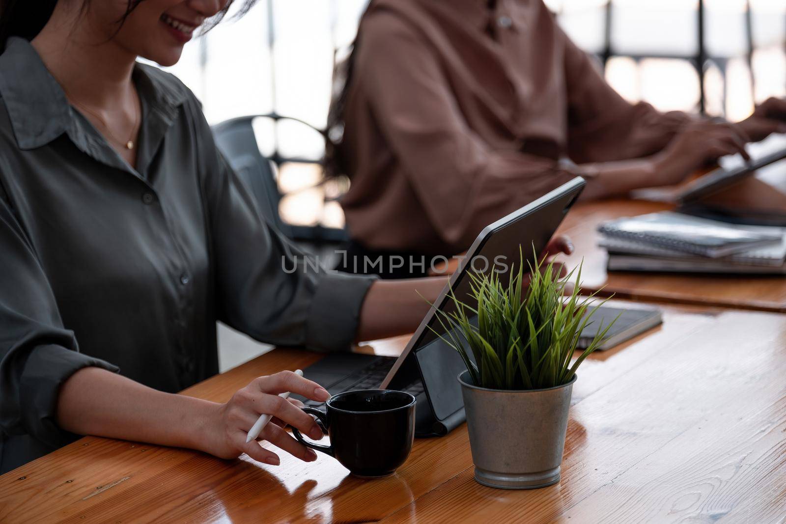 group of business people working with digital tablet at cafe.