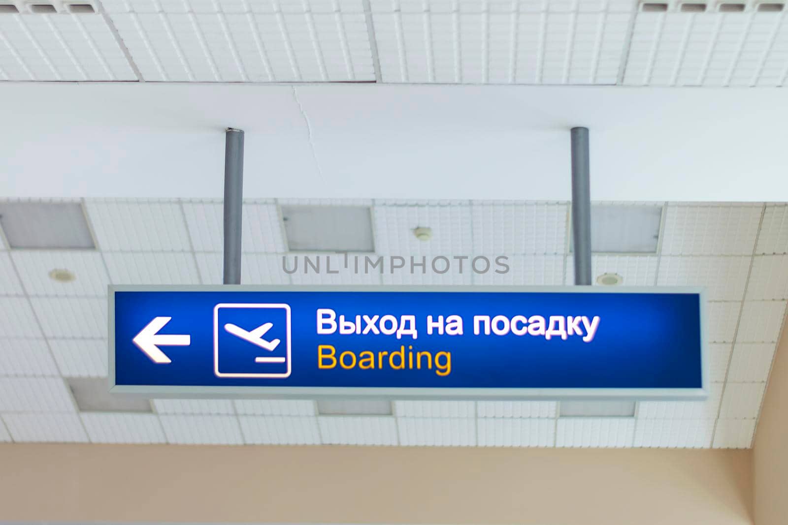 The sign at the airport is the gate. Fixed on two pipes to the ceiling. View from the front. by Essffes
