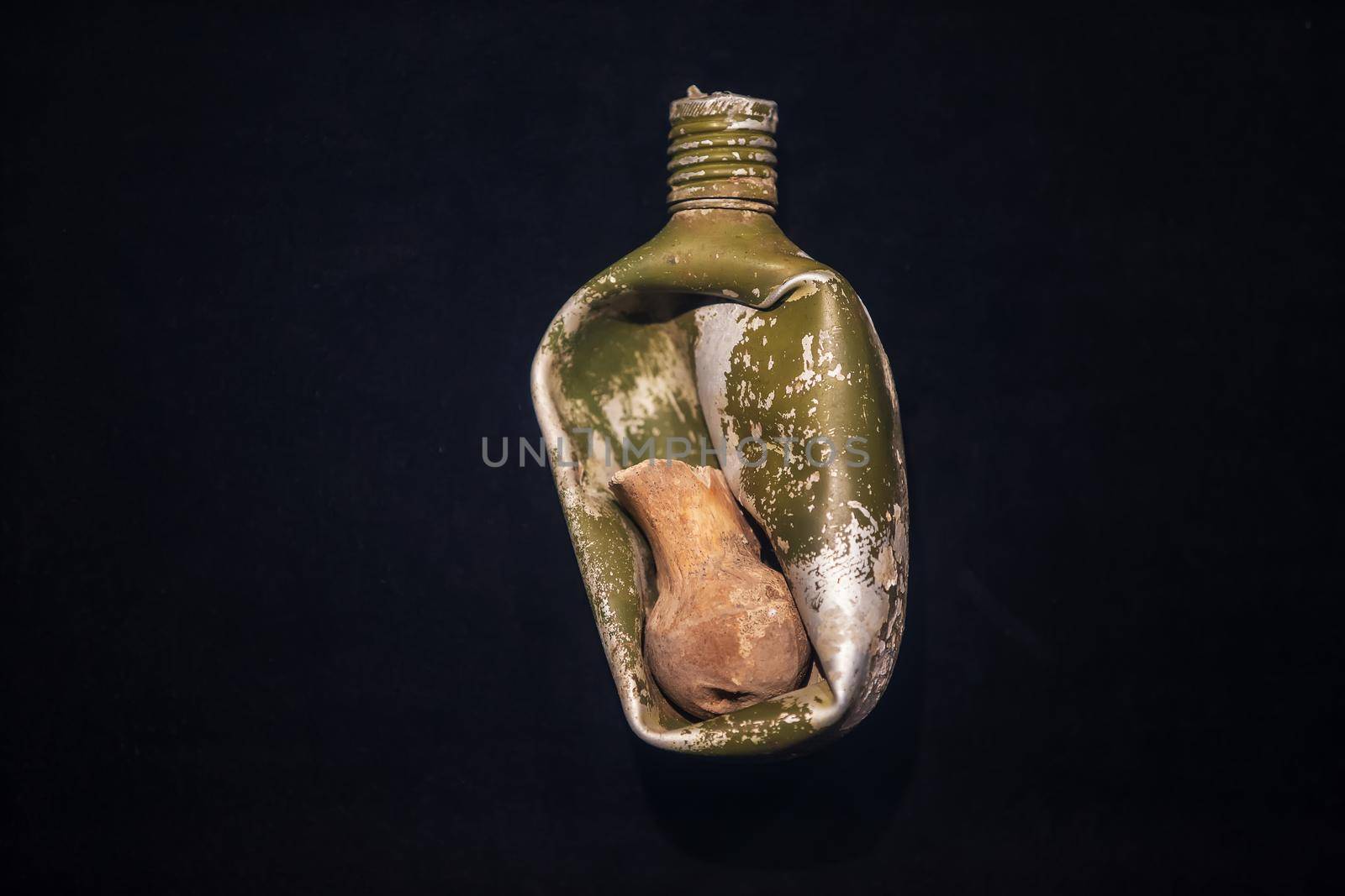 Military flask of the Second World War with the bone of a dead person during the explosion.