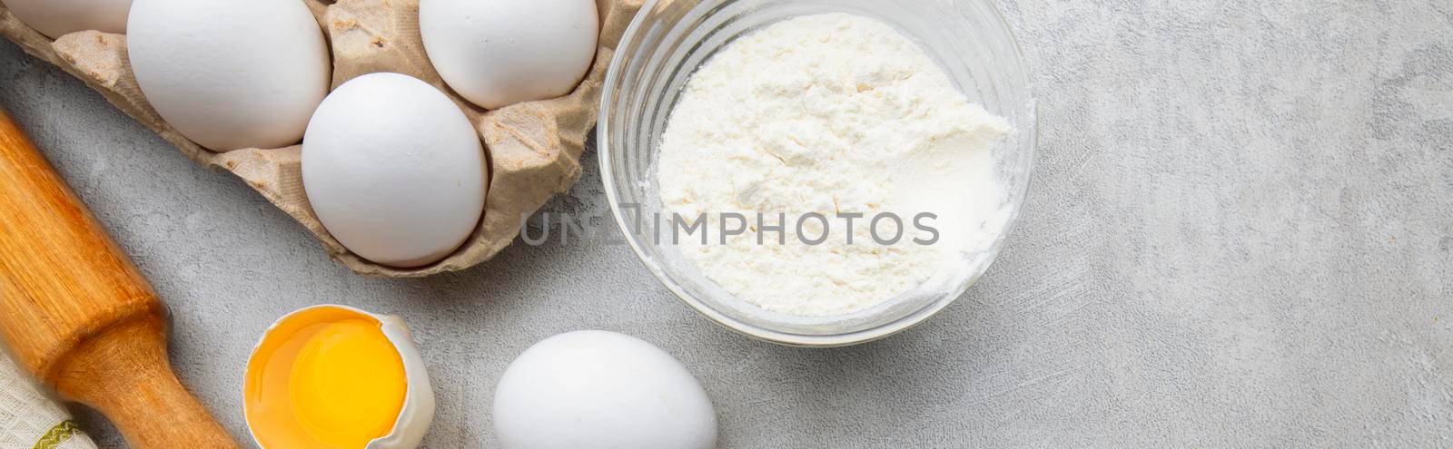Baking cooking ingredients flour eggs rolling pin and kitchen textiles on gray concrete background. Cookie pie or cake recipe mockup by Sviatlana