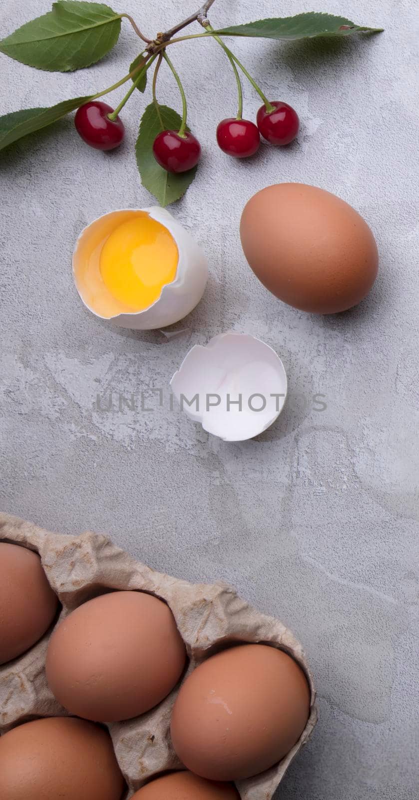 Ingredients for baking eggs rolling pin berries on a gray background. Cookie pie or cake recipe mockup. Preparing for culinary baking.