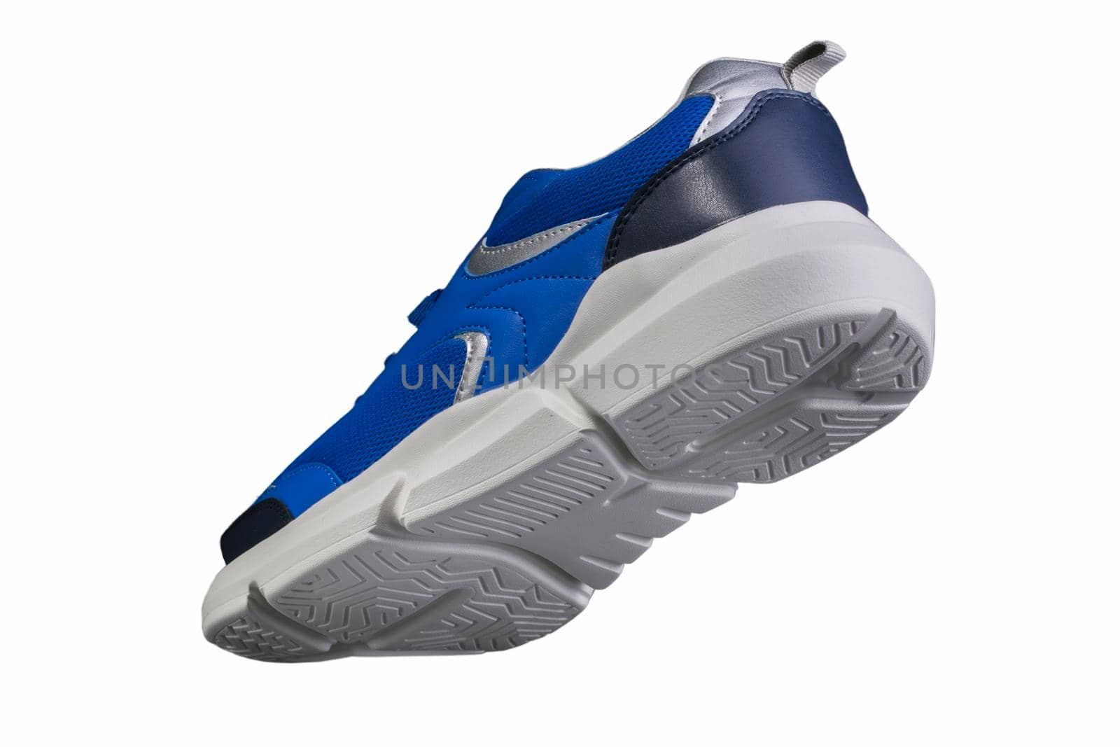 Blue sneaker made of fabric with a white sole on a white background. Sport shoes.