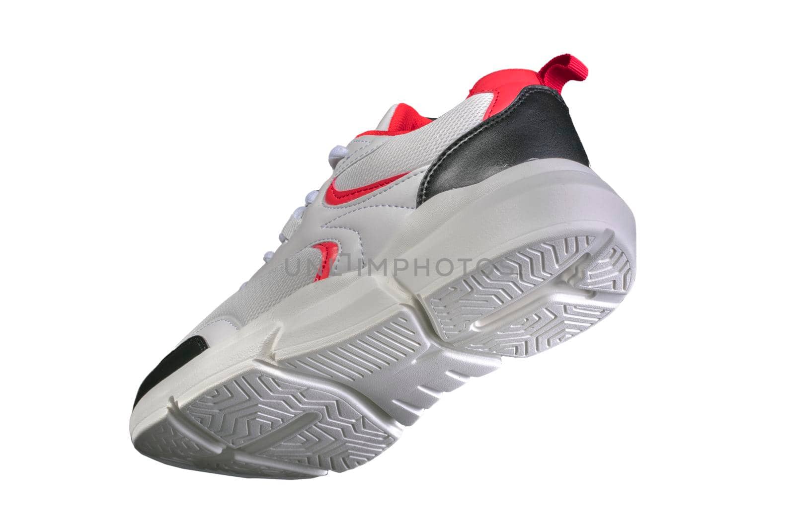 White sneaker with red and black accents on a white background. Sport shoes.