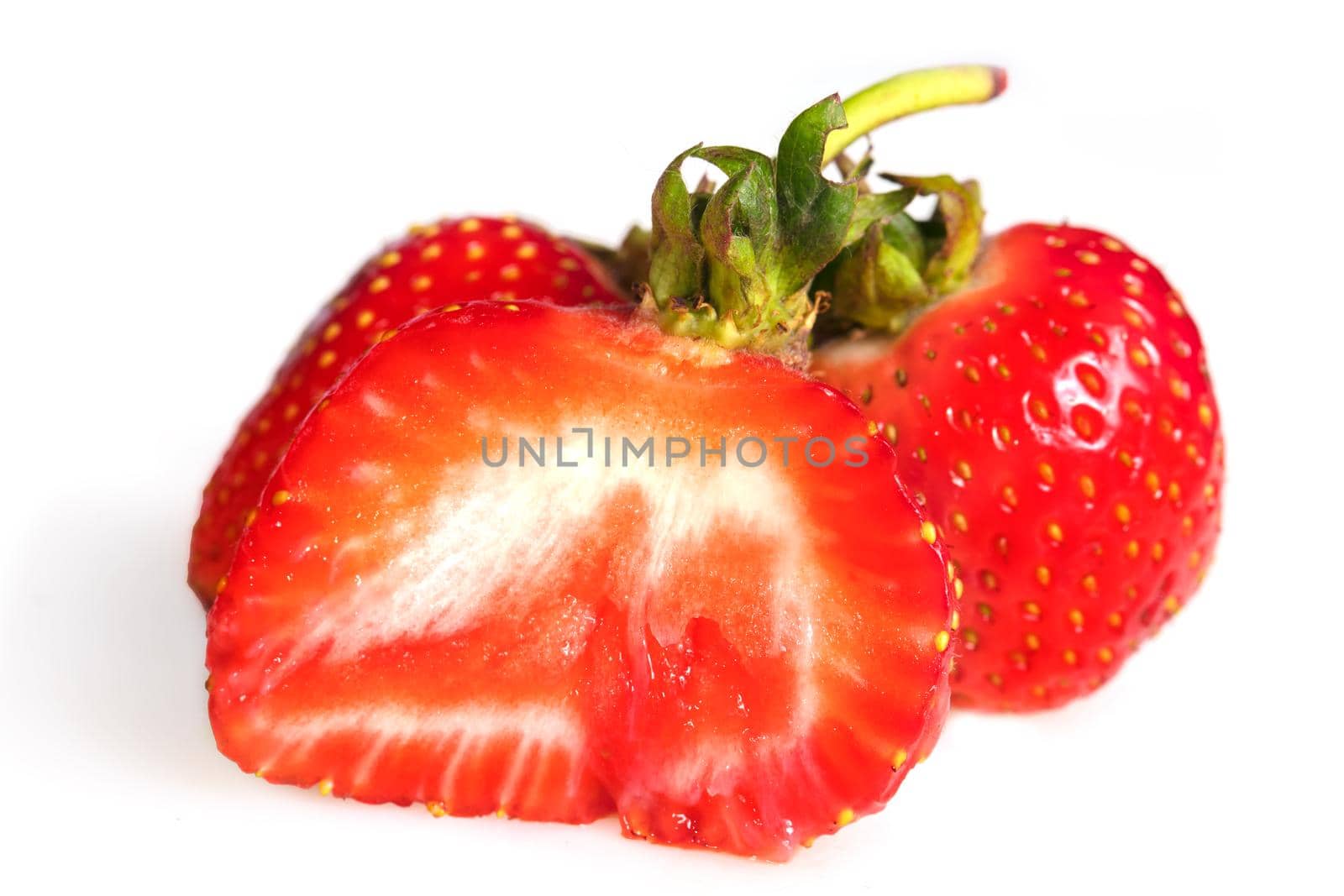 Large cut strawberries on a white background.