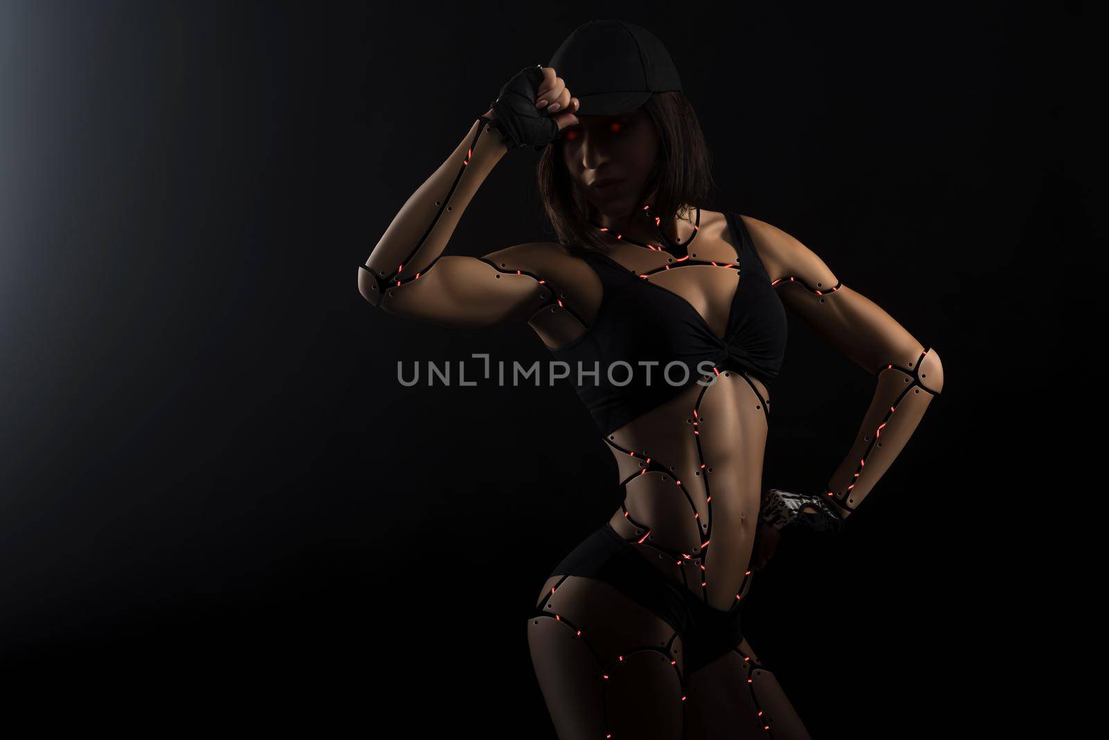 Fitness machine. Studio shot of a fitness woman wearing top and shorts photoshopped into a robot doll