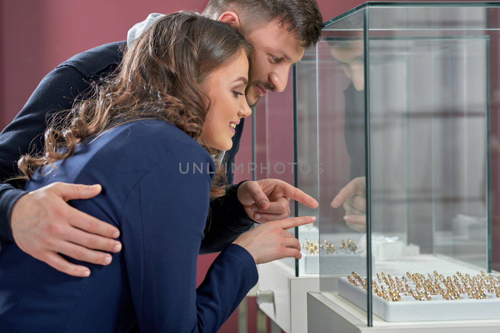 Young couple in love buying rings at the jewelry store by SerhiiBobyk