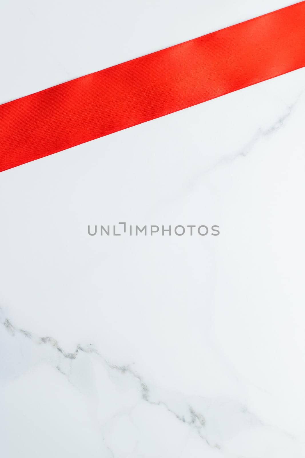 Holiday decor, feminine design and flatlay concept - Red silk ribbon on marble, top view