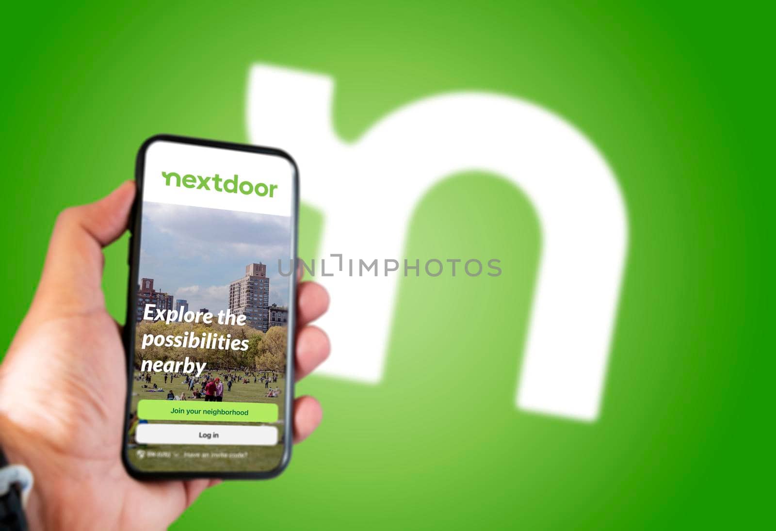San Francisco, CA, USA, May 2021: The Nextdoor application home screen on a hand held smart phone screen. Nextdoor logo blurred on the background. Nextdoor is a social network for neighborhoods