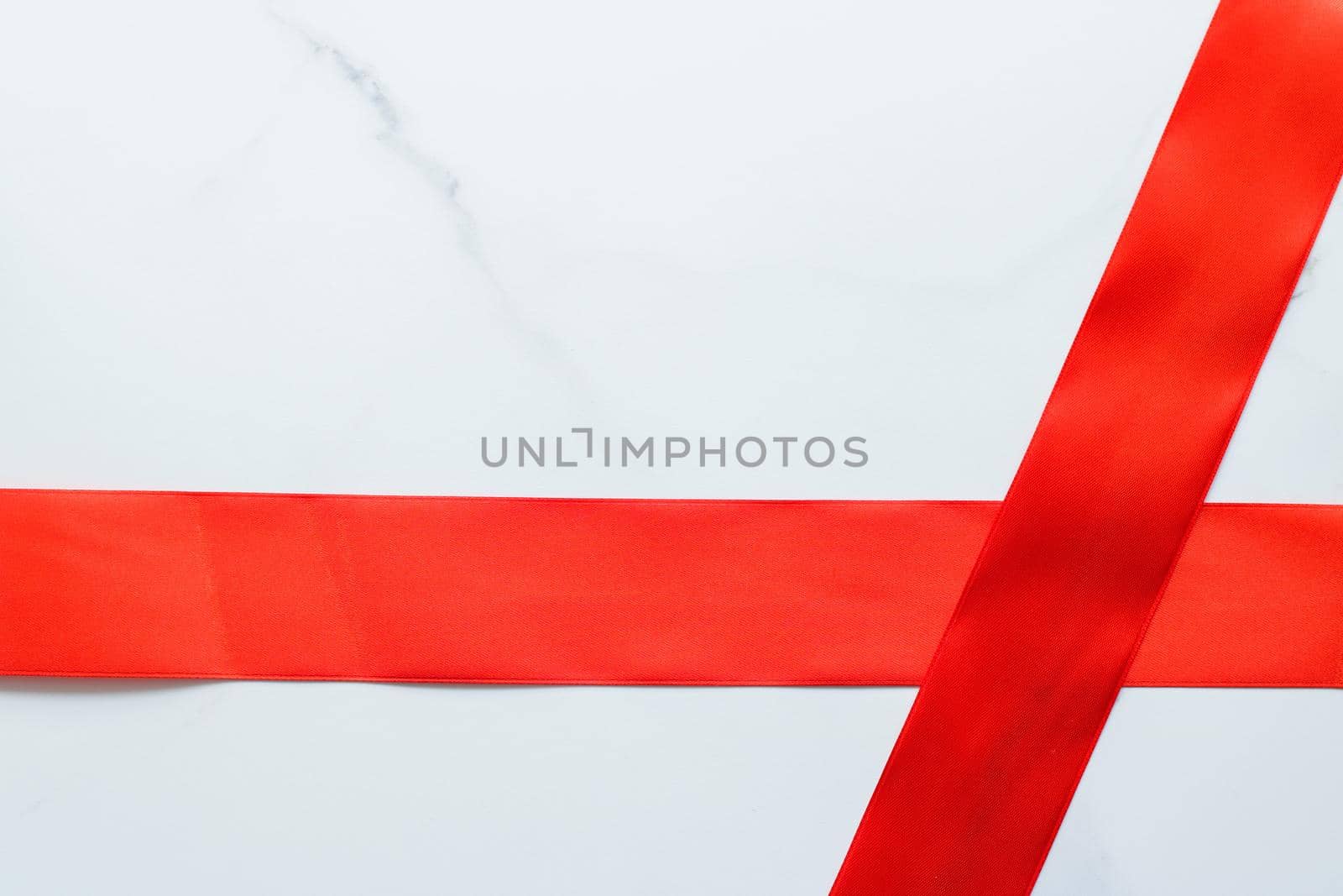 Holiday decor, feminine design and flatlay concept - Red silk ribbon on marble, top view