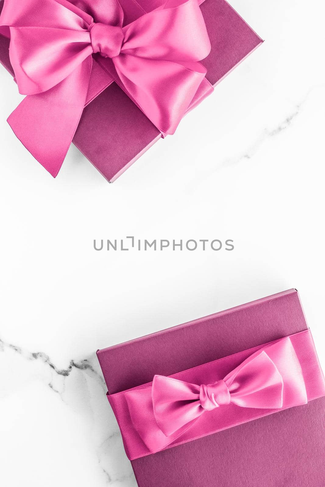 Birthday, wedding and girly branding concept - Pink gift box with silk bow on marble background, girl baby shower present and glamour fashion gift for luxury beauty brand, holiday flatlay art design