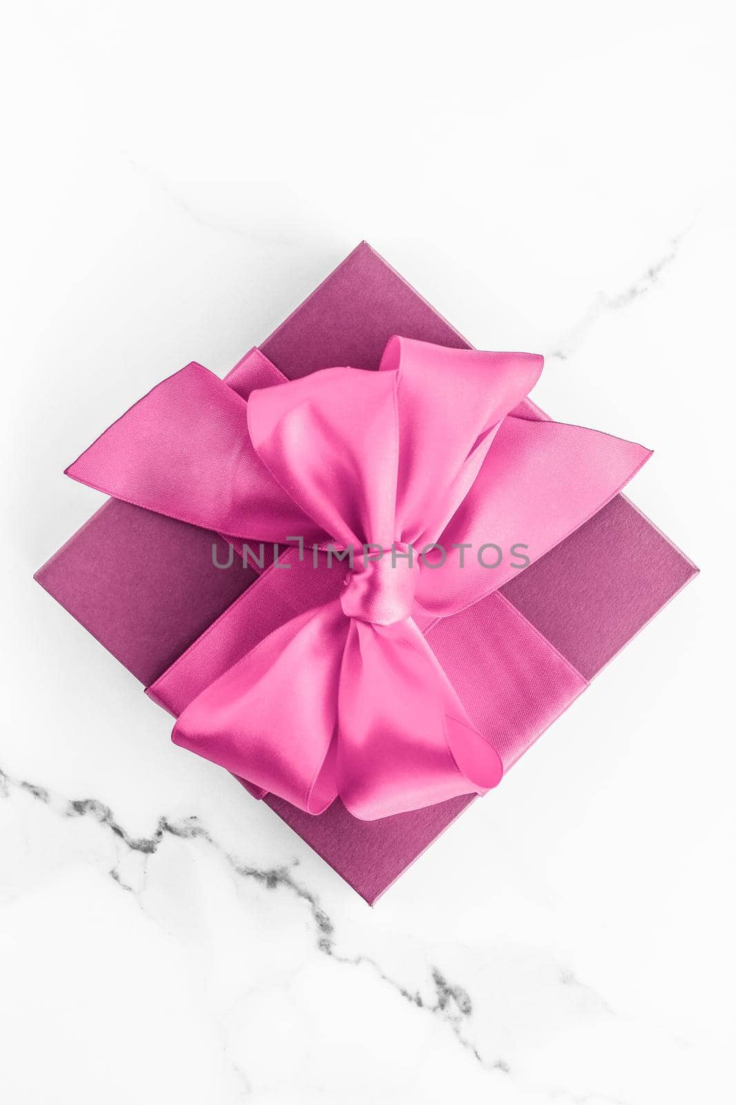 Birthday, wedding and girly branding concept - Pink gift box with silk bow on marble background, girl baby shower present and glamour fashion gift for luxury beauty brand, holiday flatlay art design