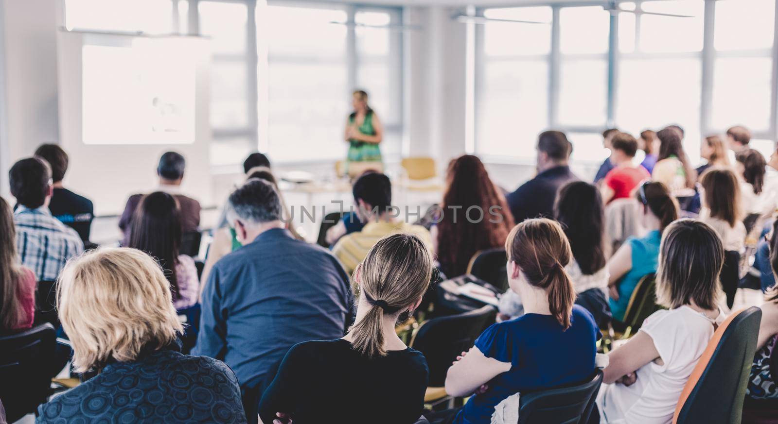 Female speaker giving presentation on business conference. by kasto