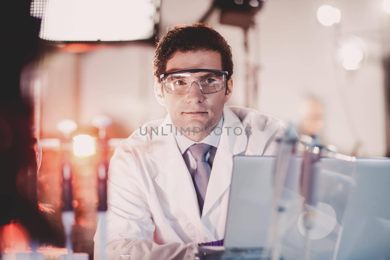 Portrait of a confident male engineer in his working environment. Science and technology concept.