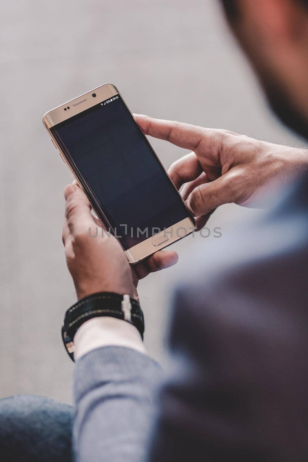Close up of a businessman using smart phone. Focus on mobile device. Copy space.